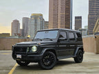 Black Mercedes-Benz G-Wagon with Boston skyline in the background