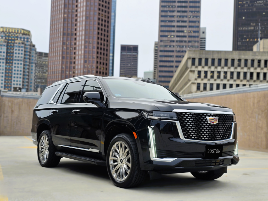 Front three-quarter view of Cadillac Escalade on a Boston rooftop parking garage