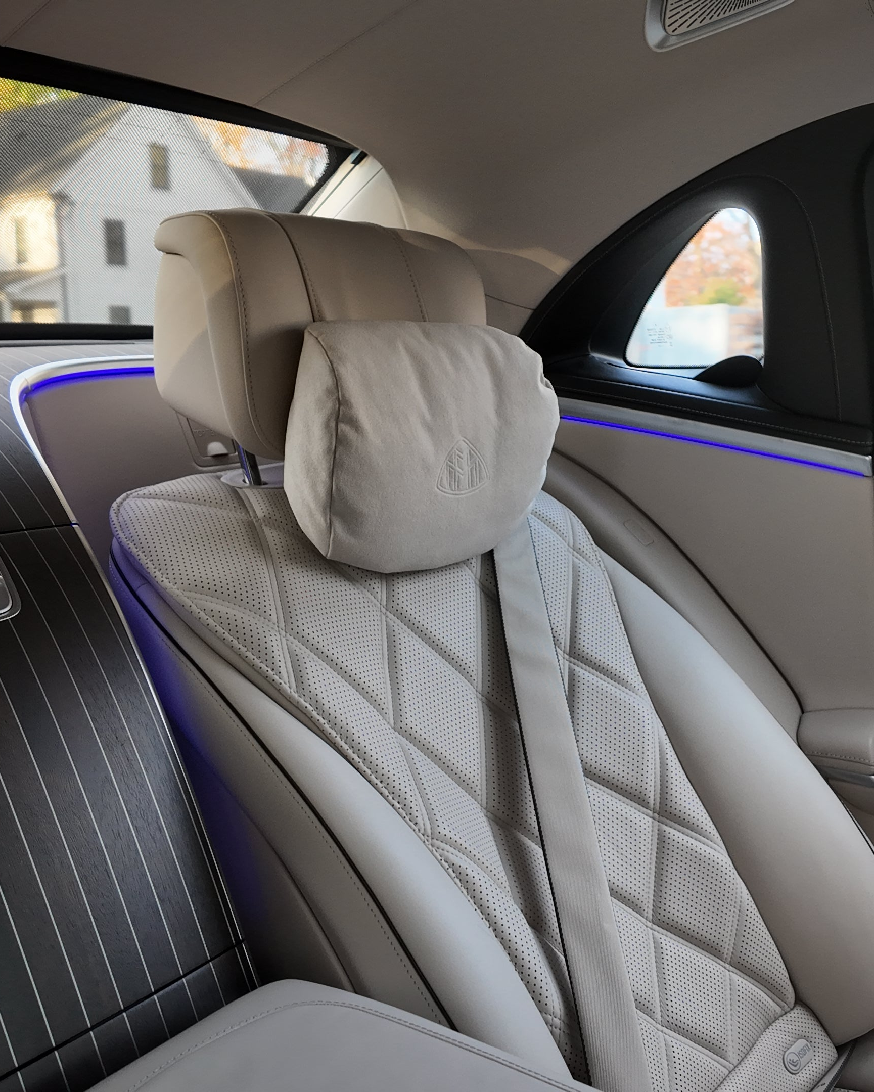 Rear passenger seat inside a luxury Maybach vehicle with premium leather interior