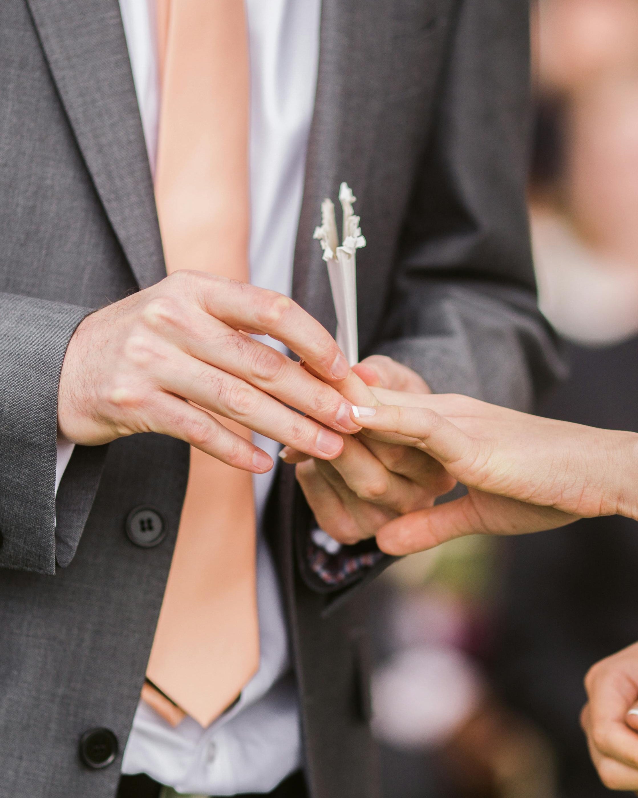 Close-up of a couple exchanging wedding rings during a ceremony