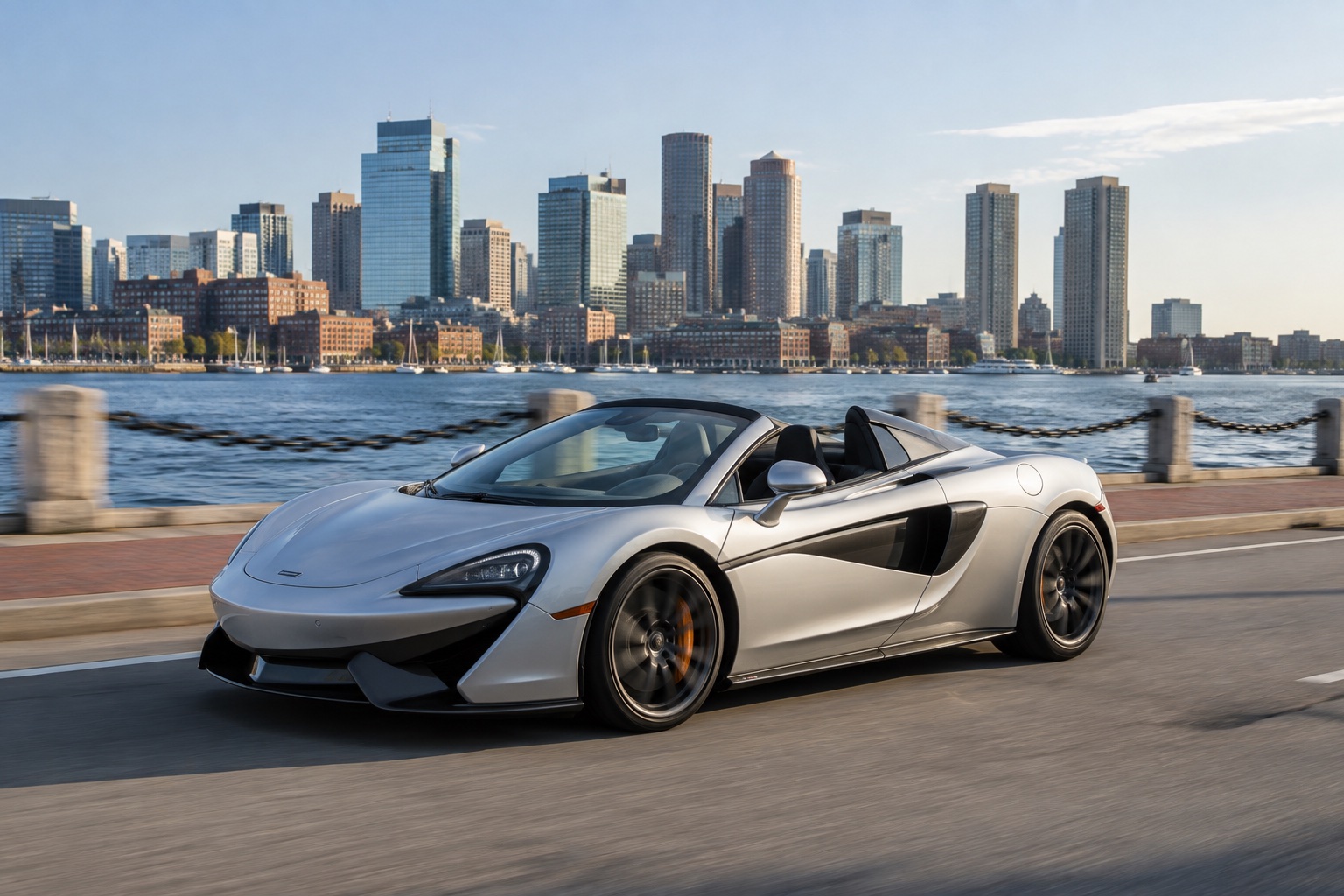 A silver supercar beside an unbranded booking phone on the Boston waterfront