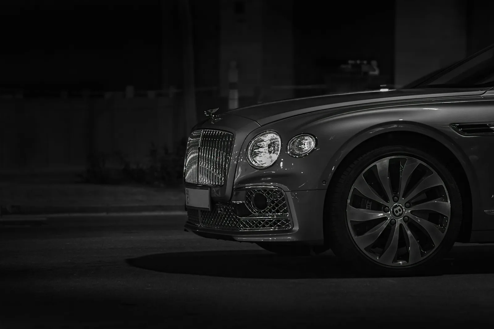 Bentley Flying Spur front grille and headlight, representing the Bentayga and Flying Spur available to rent in Boston