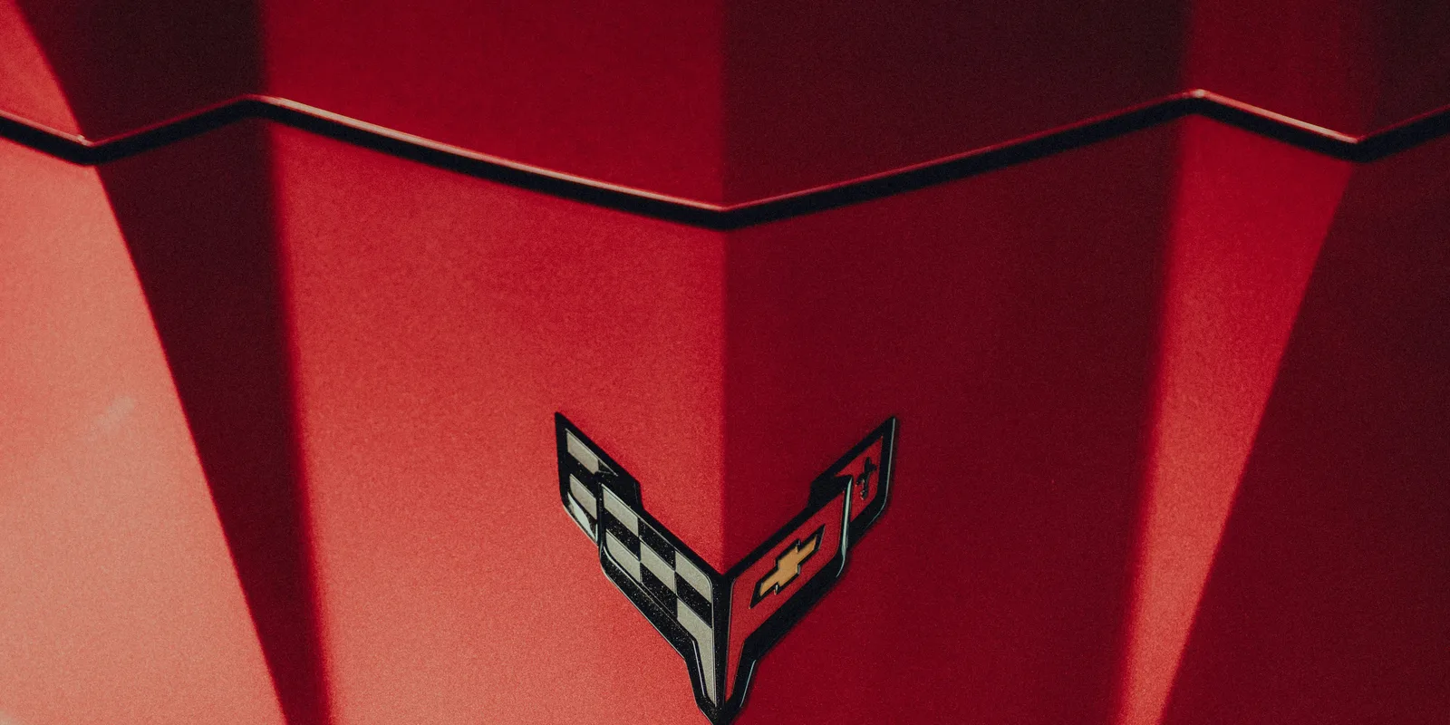 Chevrolet Corvette C8 crossed-flag badge on the hood, representing the Corvette C8 available to rent in Boston