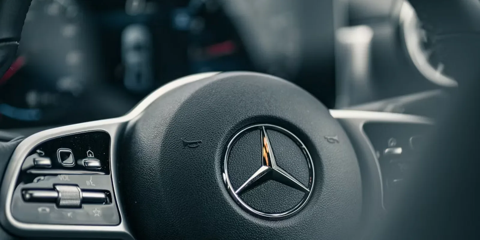 Mercedes-Benz steering wheel star emblem, representing the G550 available to rent in Boston